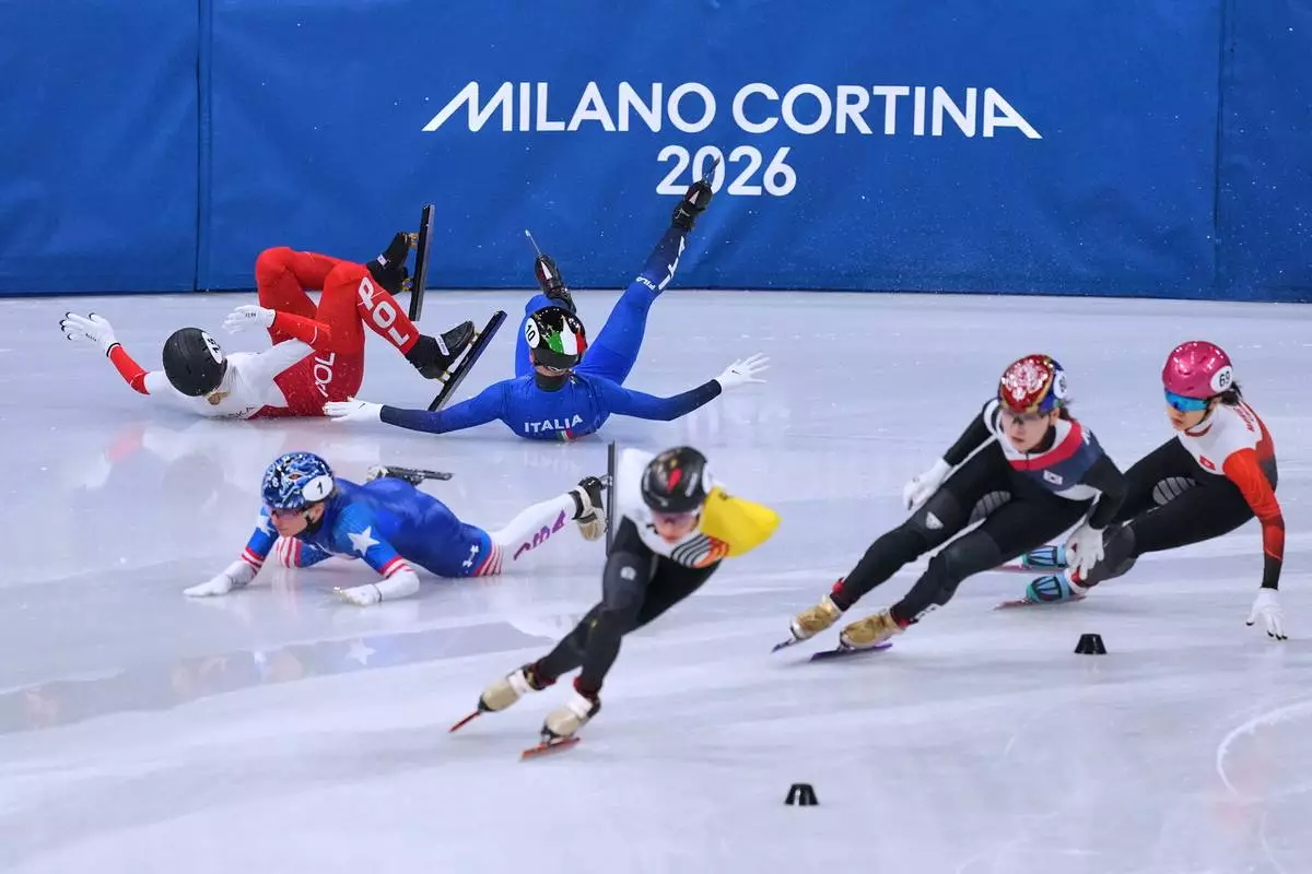 Kamila Sellier of Poland falls during a short track speed skating women's 1500 meters quarterfinal at the 2026 Winter Olympics, in Milan, Italy, Friday, Feb. 20, 2026. (AP Photo/Stephanie Scarbrough)