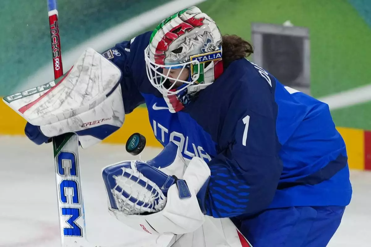 Italy's goalkeeper Gabriella Durante (1) makes a save in the third period against Germany during a preliminary round match of women's ice hockey at the 2026 Winter Olympics, in Milan, Italy, Tuesday, Feb. 10, 2026. (AP Photo/Carolyn Kaster)