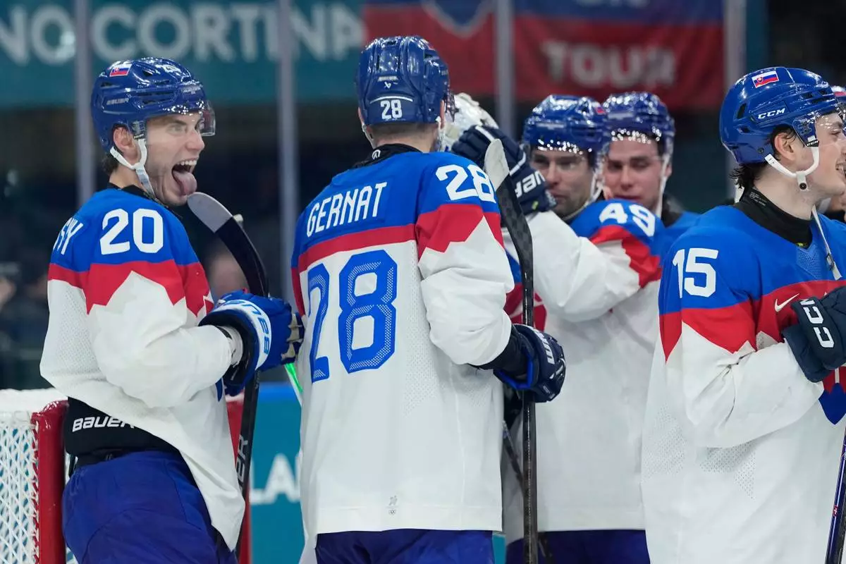 Slovakia's Juraj Slafkovsky end of a preliminary round match of men's ice hockey between Sweden and Slovakia at the 2026 Winter Olympics, in Milan, Italy, Saturday, Feb. 14, 2026. (AP Photo/Petr David Josek)