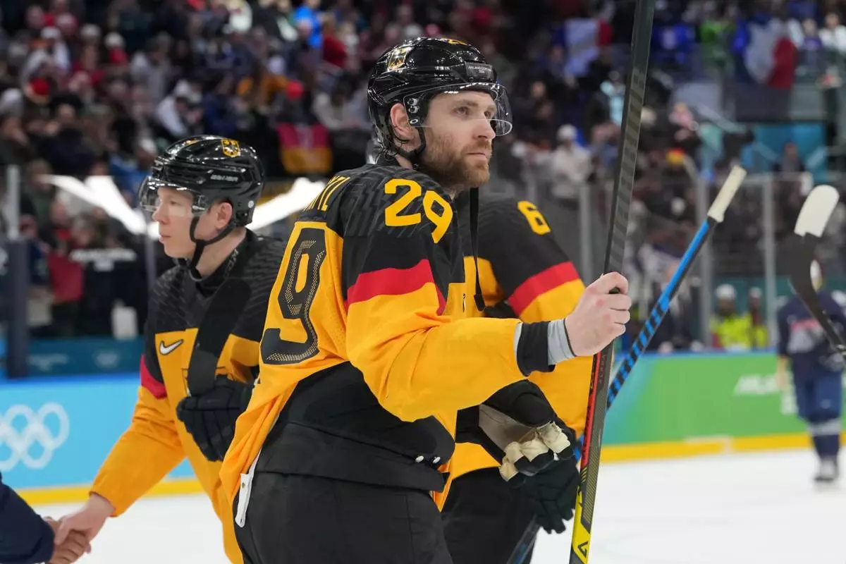 Germany's Leon Draisaitl (29) leaves the ice following a win over France in a men's ice hockey qualification playoff game at the 2026 Winter Olympics, in Milan, Italy, Tuesday, Feb. 17, 2026. (AP Photo/Carolyn Kaster)