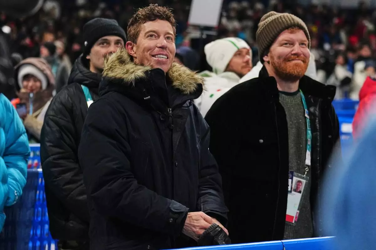 Shaun White watches competition during the men's snowboarding halfpipe qualifications at the 2026 Winter Olympics, in Livigno, Italy, Wednesday, Feb. 11, 2026. (AP Photo/Abbie Parr)