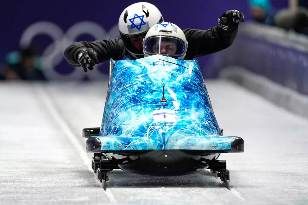 Israel's Adam Edelman, front, starts for a two man bobsled training session at the 2026 Winter Olympics, in Cortina d'Ampezzo, Italy, Saturday, Feb. 14, 2026. (AP Photo/Aijaz Rahi)