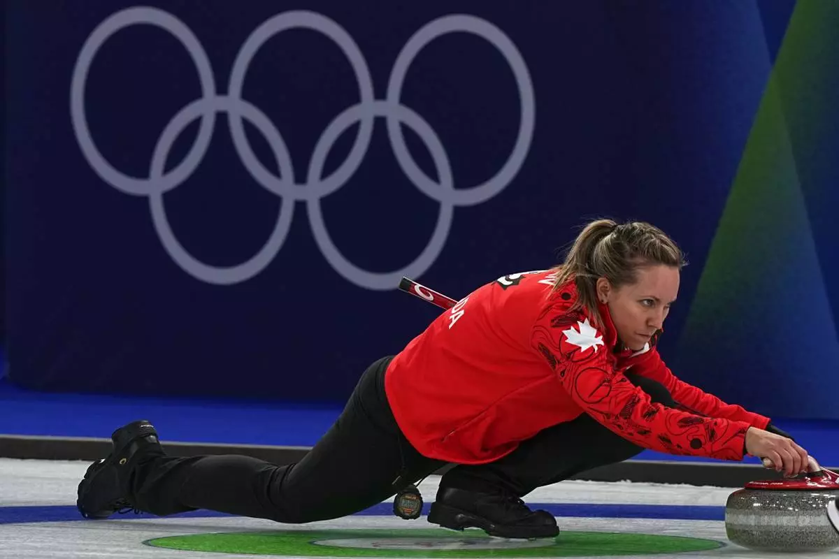 Canada's Rachel Homan in action during the women's curling round robin session against Switzerland at the 2026 Winter Olympics, in Cortina d'Ampezzo, Italy, Saturday, Feb. 14, 2026. (AP Photo/Fatima Shbair)