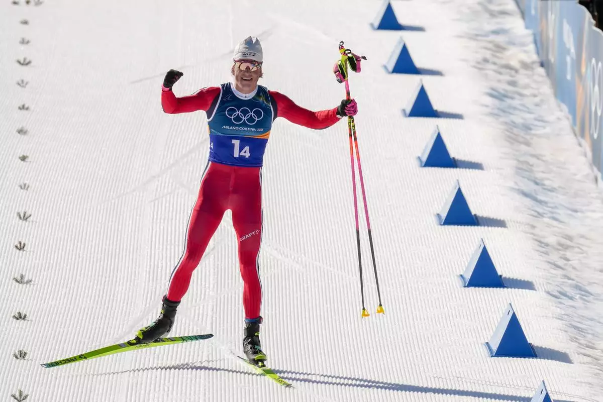 Johannes Hoesflot Klaebo, of Norway, approaches the finish line to win the gold medal in the cross country skiing men's 4 x 7.5km relay at the 2026 Winter Olympics, in Tesero, Italy, Sunday, Feb. 15, 2026. (AP Photo/Evgeniy Maloletka)