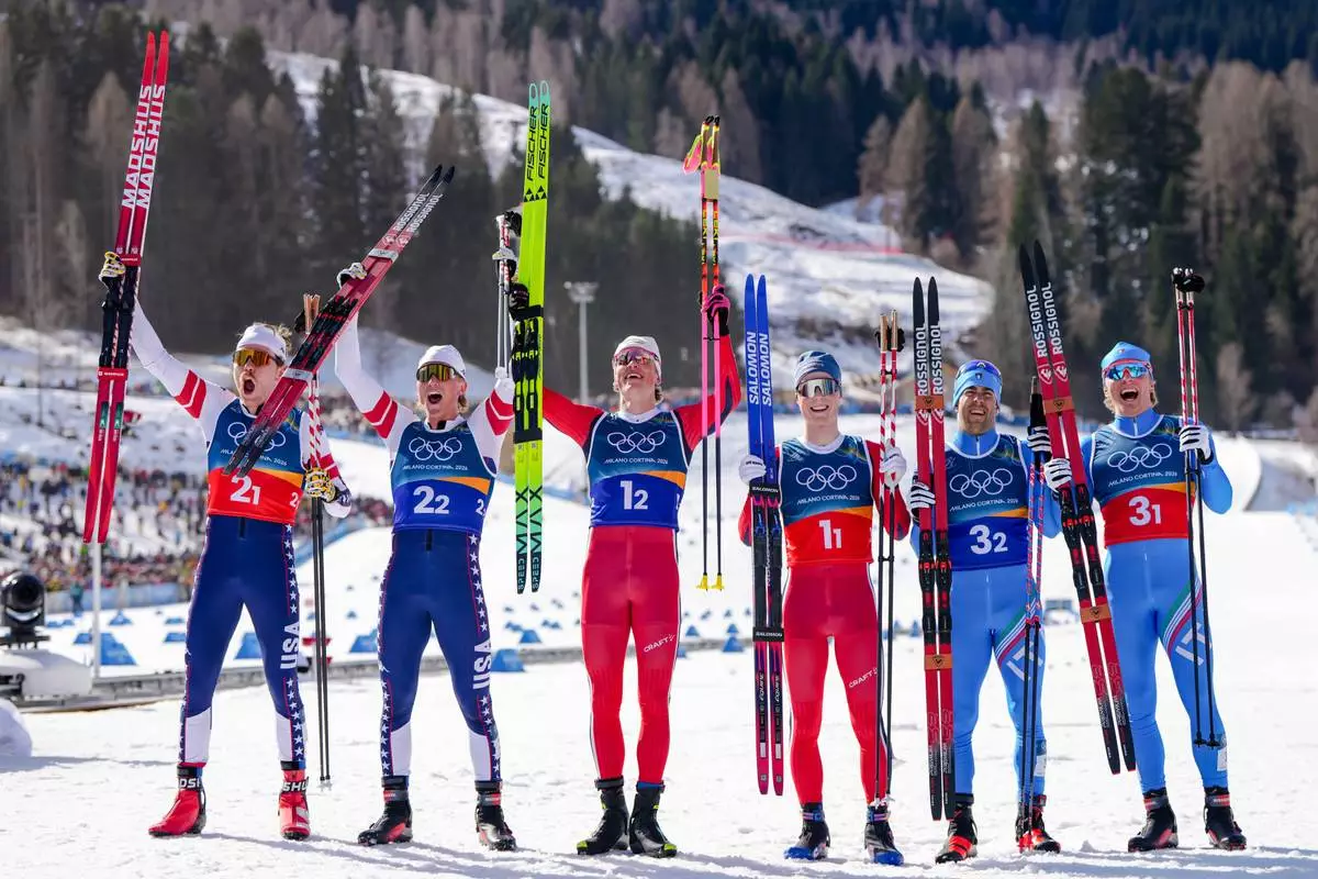Silver medalists Ben Ogden and Gus Schumacher, of the United States, gold medalists Johannes Hoesflot Klaebo and Einar Hedegart, of Norway, and bronze medalists Federico Pellegrino and Elia Barp, of Italy, pose after the cross-country skiing men's team sprint free at the 2026 Winter Olympics, in Tesero, Italy, Wednesday, Feb. 18, 2026. (AP Photo/Kirsty Wigglesworth)