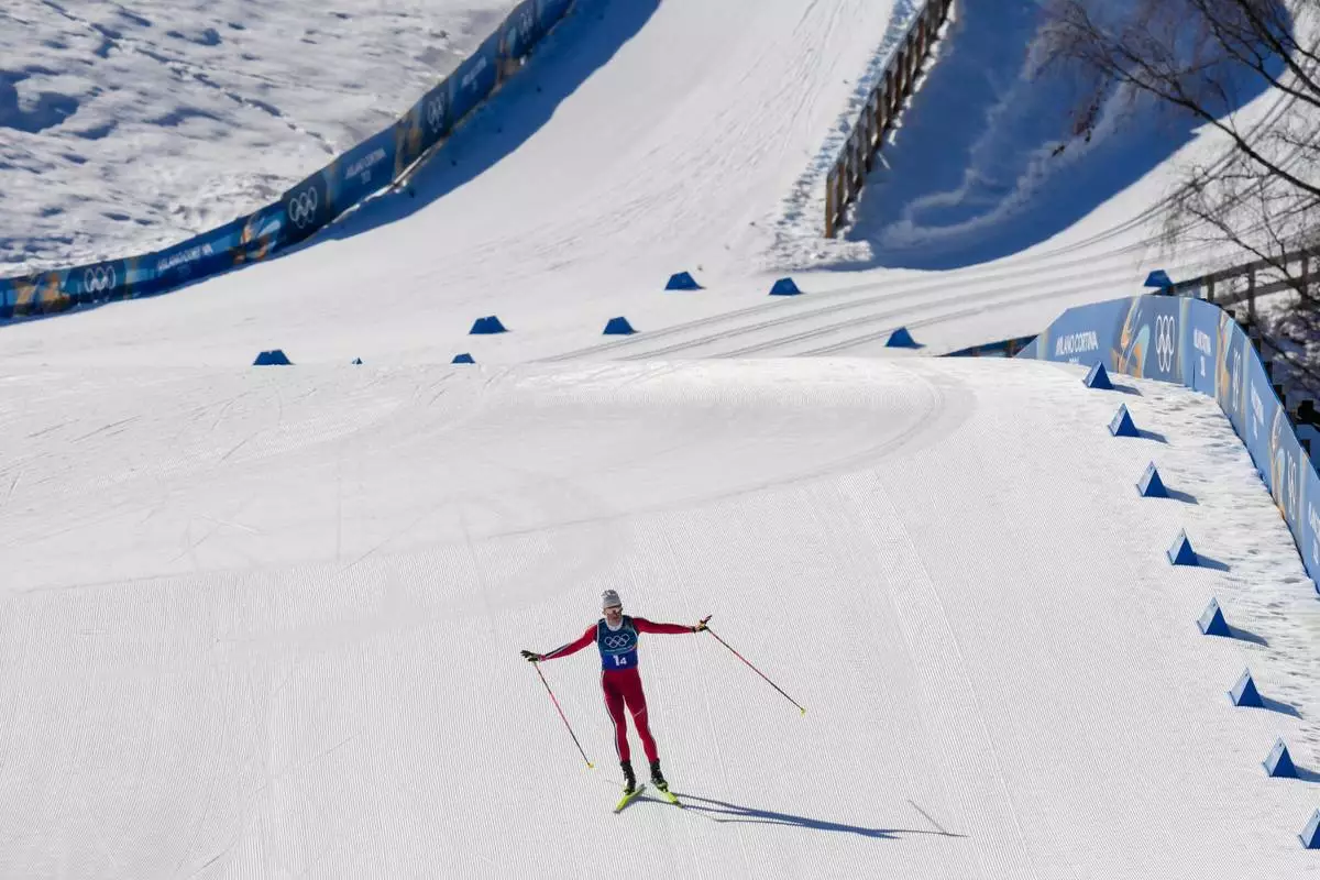 Johannes Hoesflot Klaebo, of Norway, approaches the finish line to win the gold medal in the cross country skiing men's 4 x 7.5km relay at the 2026 Winter Olympics, in Tesero, Italy, Sunday, Feb. 15, 2026. (AP Photo/Evgeniy Maloletka)