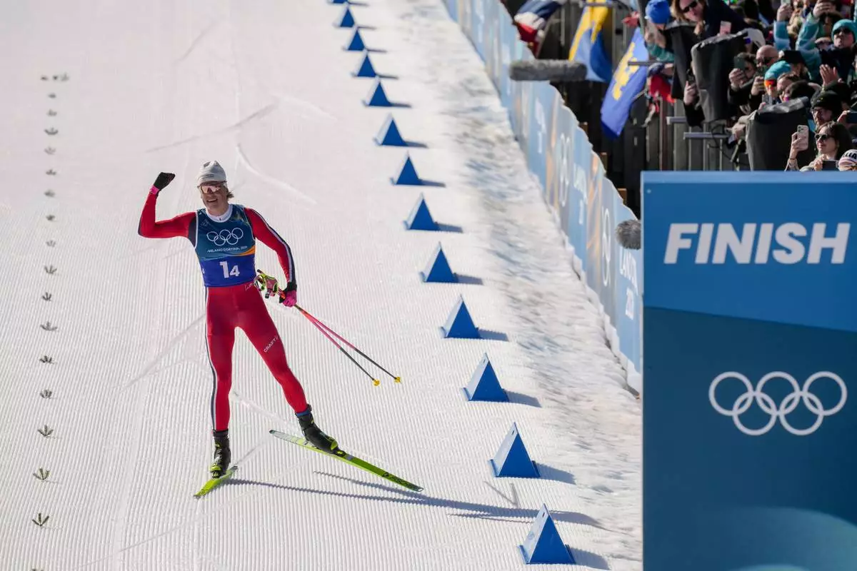 Johannes Hoesflot Klaebo, of Norway, approaches the finish line to win the gold medal in the cross country skiing men's 4 x 7.5km relay at the 2026 Winter Olympics, in Tesero, Italy, Sunday, Feb. 15, 2026. (AP Photo/Evgeniy Maloletka)