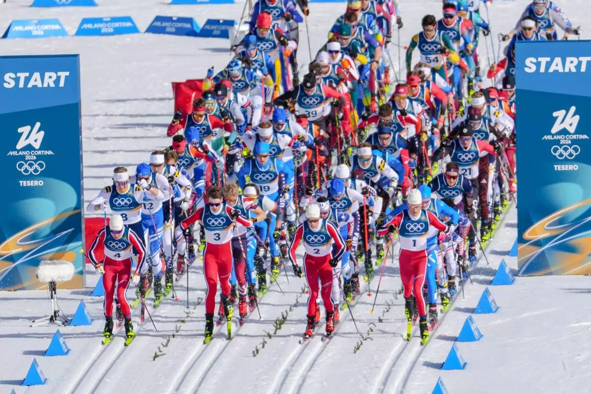 Johannes Hoesflot Klaebo, of Norway, foreground right, start in the cross country skiing men's 10km + 10km skiathlon at the 2026 Winter Olympics, in Tesero, Italy, Sunday, Feb. 8, 2026. (AP Photo/Kirsty Wigglesworth)