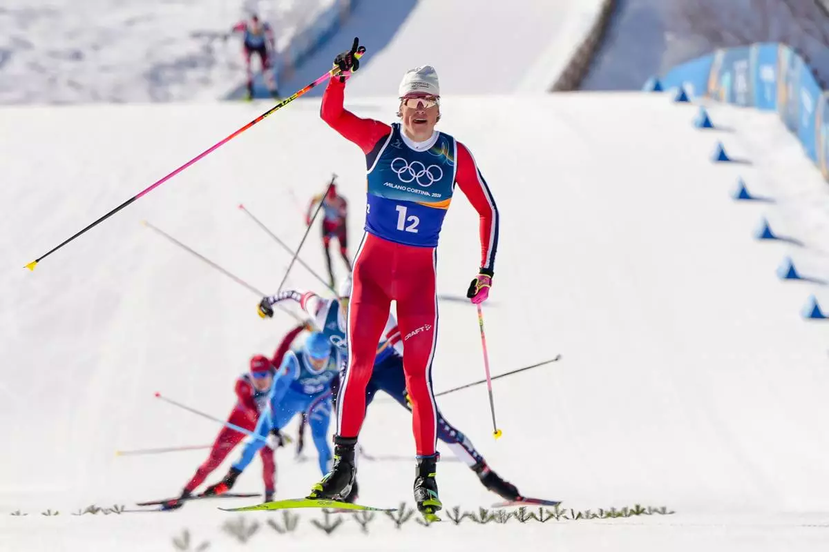 Johannes Hoesflot Klaebo, of Norway, approaches the finish line to win the gold medal in the cross-country skiing men's team sprint free at the 2026 Winter Olympics, in Tesero, Italy, Wednesday, Feb. 18, 2026. (AP Photo/Kirsty Wigglesworth)