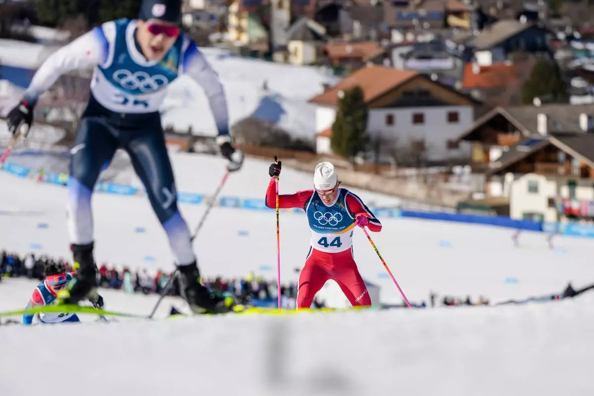 Johannes Hoesflot Klaebo, right, of Norway, competes in the cross country skiing men's 10km interval start free at the 2026 Winter Olympics, in Tesero, Italy, Friday, Feb. 13, 2026. (AP Photo/Kirsty Wigglesworth)