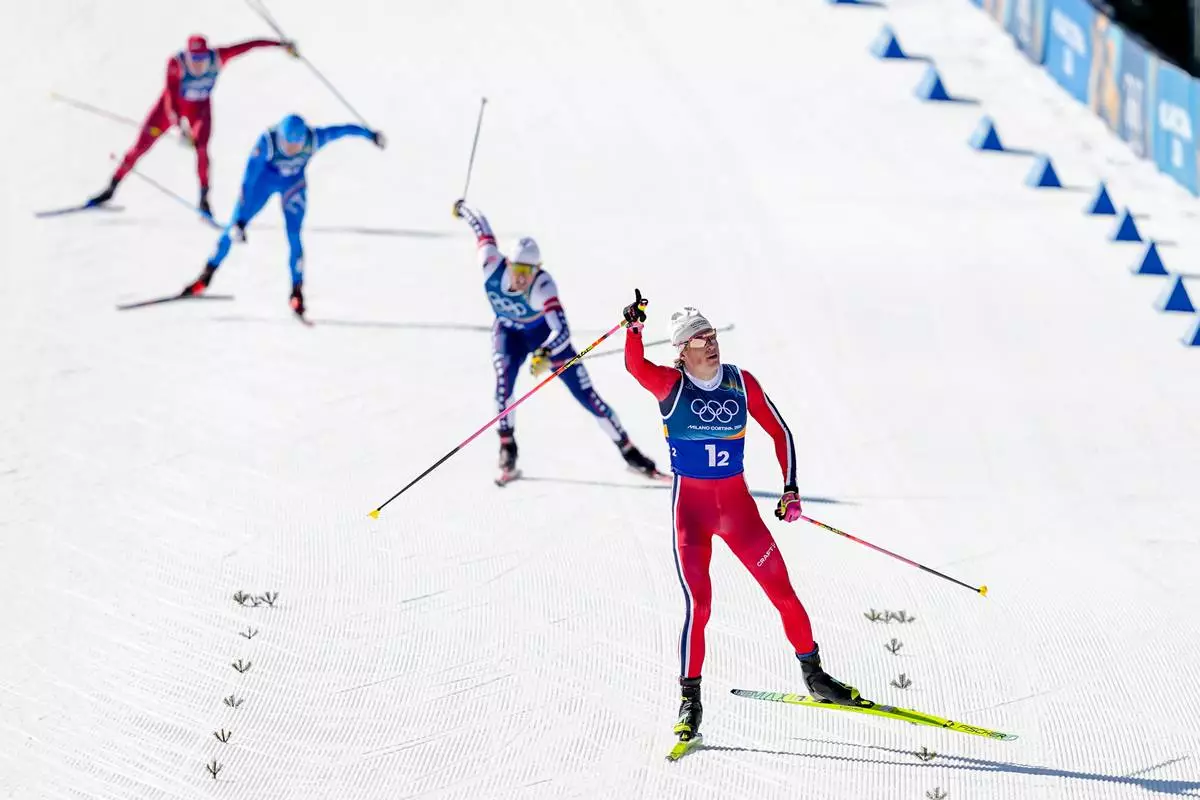 Johannes Hoesflot Klaebo, of Norway, approaches the finish line to win the gold medal in the cross-country skiing men's team sprint free at the 2026 Winter Olympics, in Tesero, Italy, Wednesday, Feb. 18, 2026. (AP Photo/Matthias Schrader)