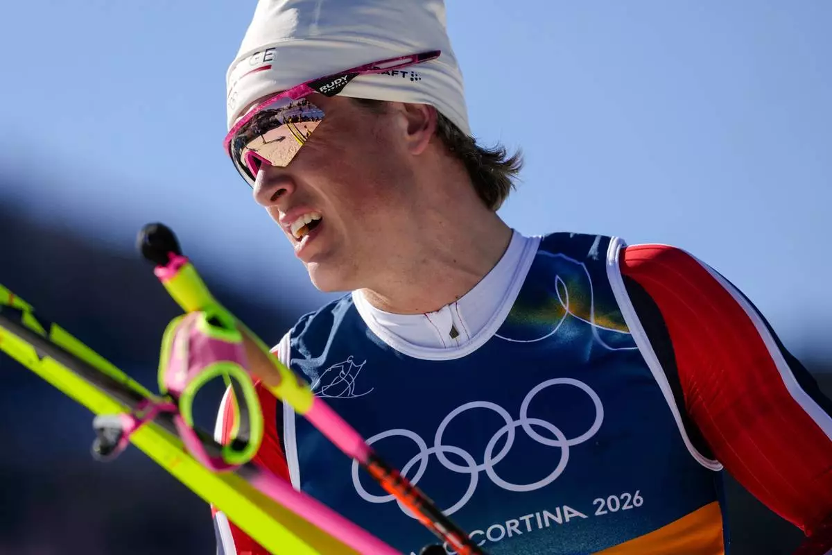 Johannes Hoesflot Klaebo, of Norway, reacts after crossing the finish line in the cross country skiing men's 10km interval start free at the 2026 Winter Olympics, in Tesero, Italy, Friday, Feb. 13, 2026. (AP Photo/Evgeniy Maloletka)