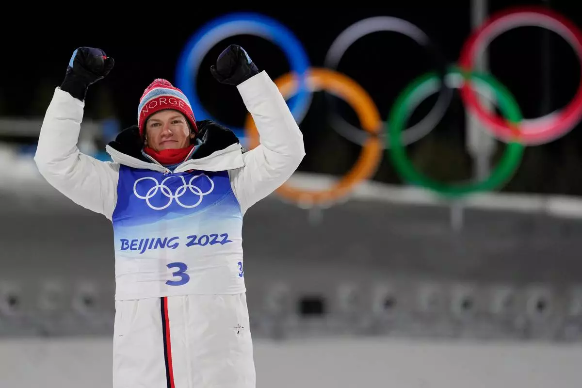 FILE - Gold medal finisher Johannes Hoesflot Klaebo, of Norway, celebrates during a venue ceremony after the men's sprint free cross-country skiing competition at the 2022 Winter Olympics, Feb. 8, 2022, in Zhangjiakou, China. (AP Photo/Alessandra Tarantino, File)