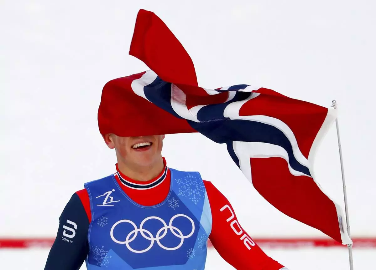 FILE - Johannes Hoesflot Klaebo, of Norway, celebrates after winning the gold medal in the men's 4 x 10km relay cross-country skiing competition at the 2018 Winter Olympics in Pyeongchang, South Korea, Feb. 18, 2018. (AP Photo/Matthias Schrader, File)