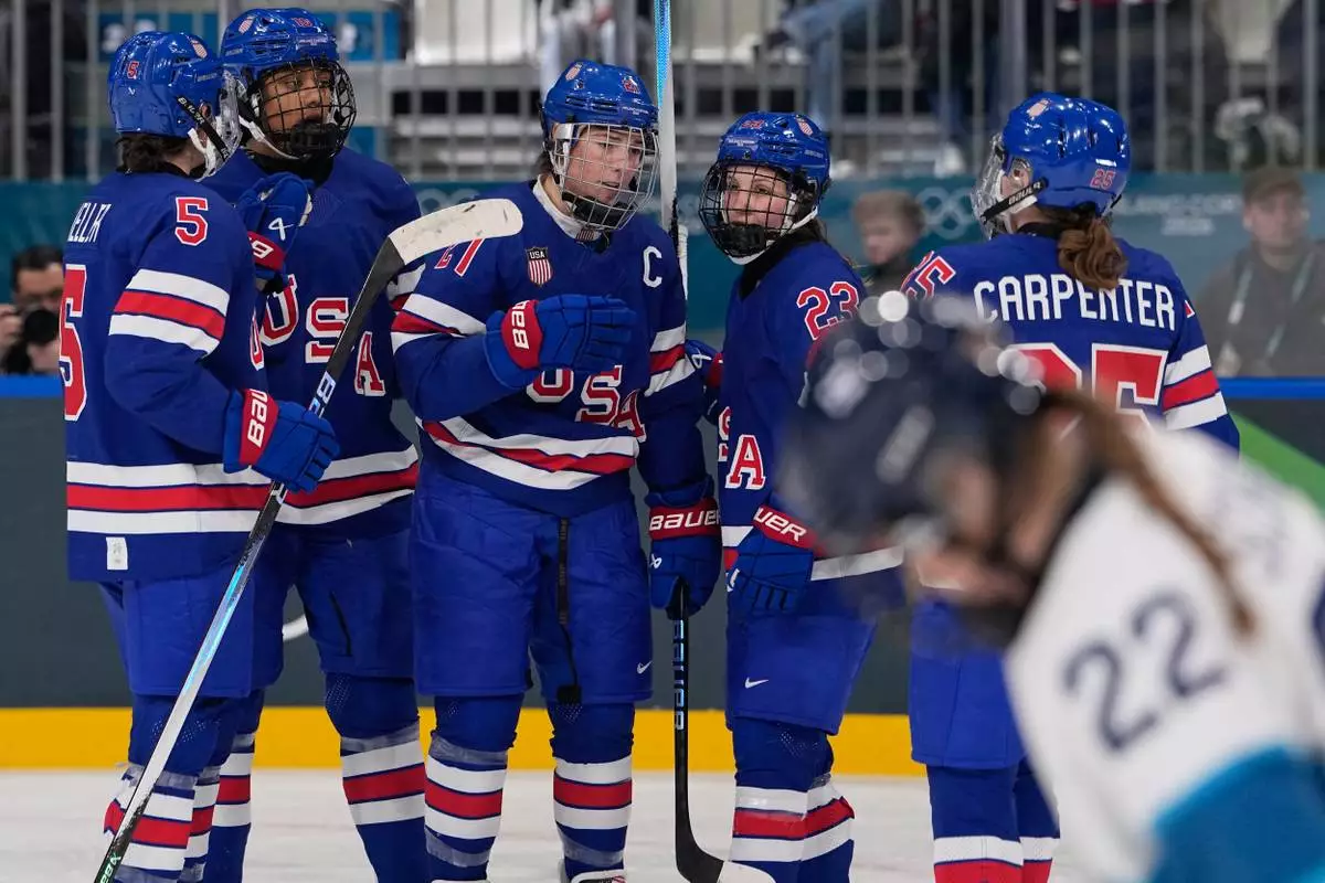 United States' Hilary Knight celebrates with teammates after scoring her sides fourth goal during a preliminary round match of women's ice hockey between the United States and Finland at the 2026 Winter Olympics, in Milan, Italy, Saturday, Feb. 7, 2026. (AP Photo/Petr David Josek)