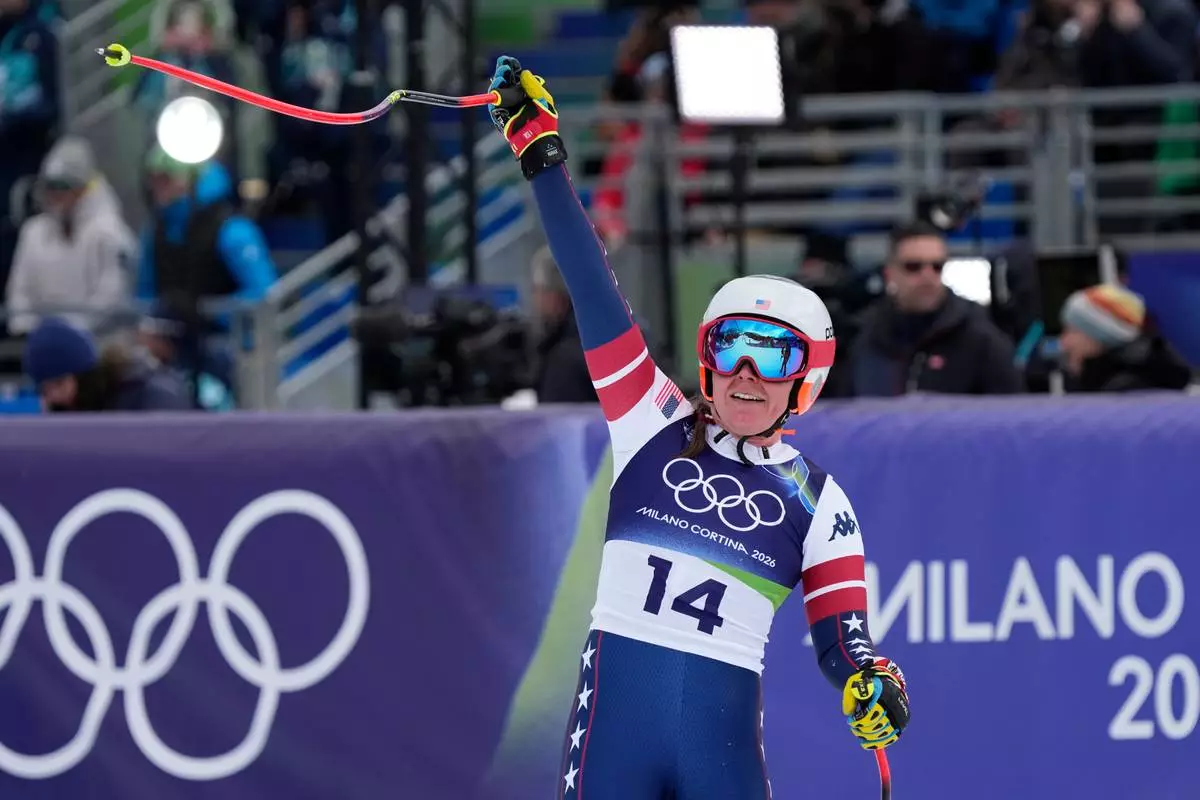 United States' Breezy Johnson celebrates at the finish area of an alpine ski, downhill portion of a women's team combined race, at the 2026 Winter Olympics, in Cortina d'Ampezzo, Italy, Tuesday, Feb. 10, 2026. (AP Photo/Andy Wong)