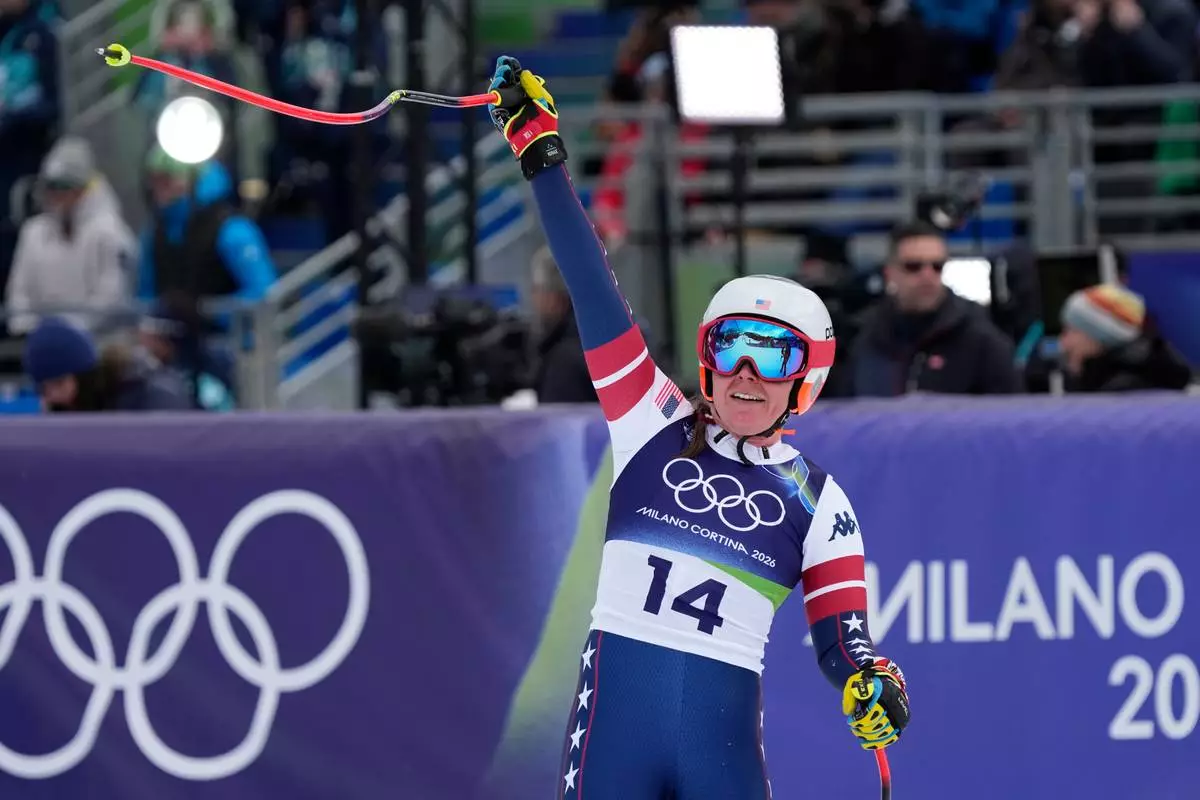 United States' Breezy Johnson celebrates at the finish area of an alpine ski, downhill portion of a women's team combined race, at the 2026 Winter Olympics, in Cortina d'Ampezzo, Italy, Tuesday, Feb. 10, 2026. (AP Photo/Andy Wong)