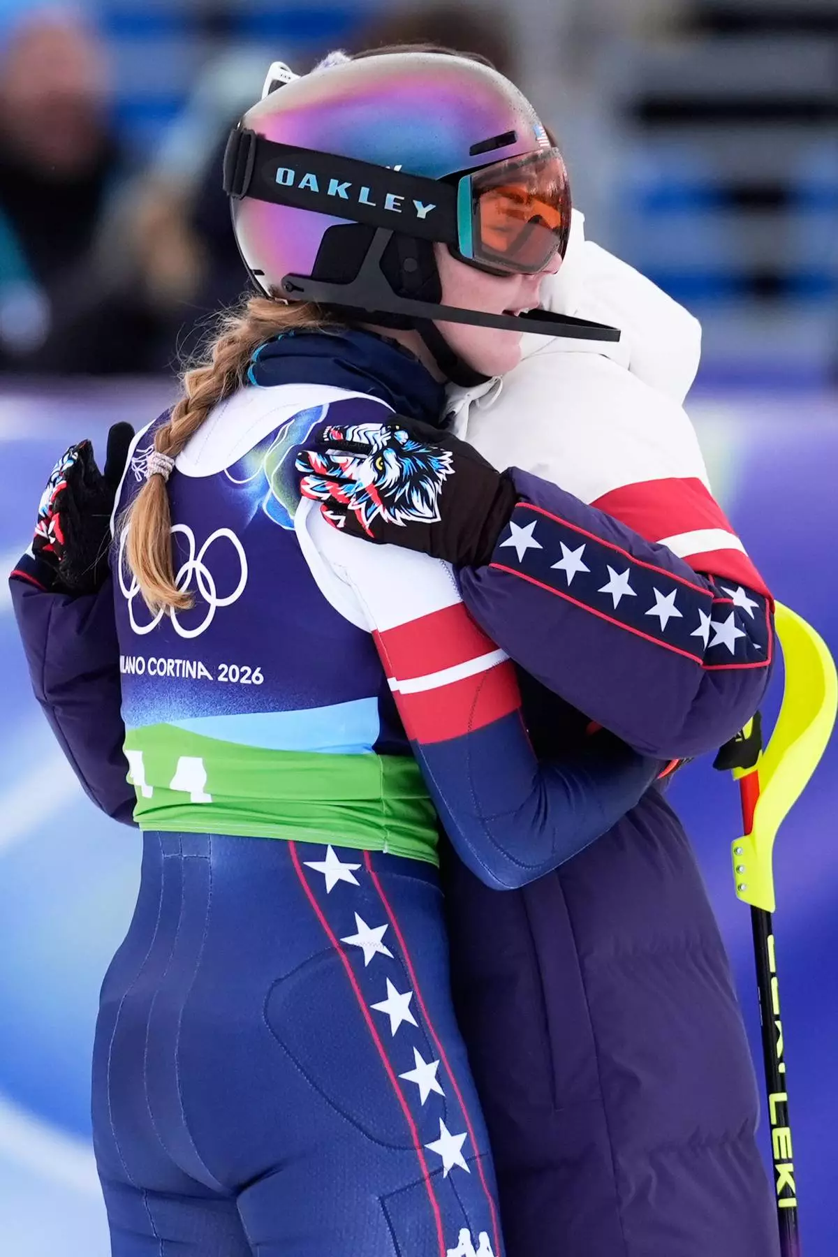United States' Mikaela Shiffrin, left, hugs teammates at the finish area during an alpine ski, slalom portion of a women's team combined race, at the 2026 Winter Olympics, in Cortina d'Ampezzo, Italy, Tuesday, Feb. 10, 2026. (AP Photo/Robert F. Bukaty)
