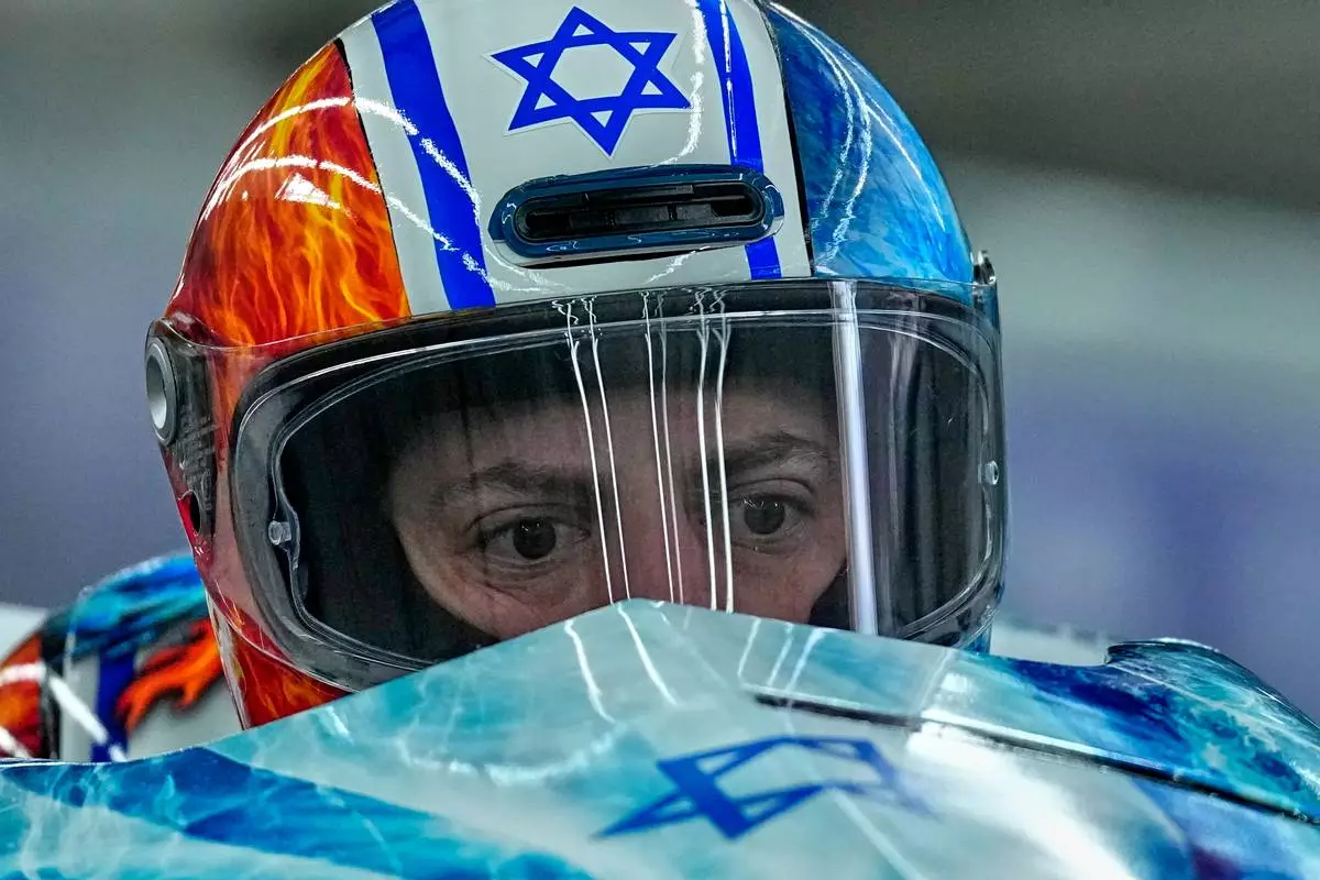 Israel's Adam Edelman, front, and Menachem Chen start for a two man bobsled run at the 2026 Winter Olympics, in Cortina d'Ampezzo, Italy, Monday, Feb. 16, 2026. (AP Photo/Alessandra Tarantino)
