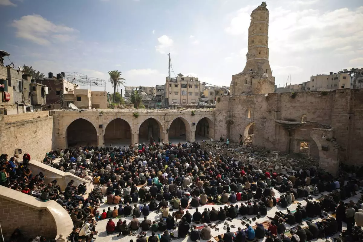 FILE - Palestinians gather to attend Friday prayers at the Great Omari Mosque, which was damaged during the Israeli military's air and ground operation in Gaza City, Friday, Feb. 14, 2025. (AP Photo/Jehad Alshrafi, File)
