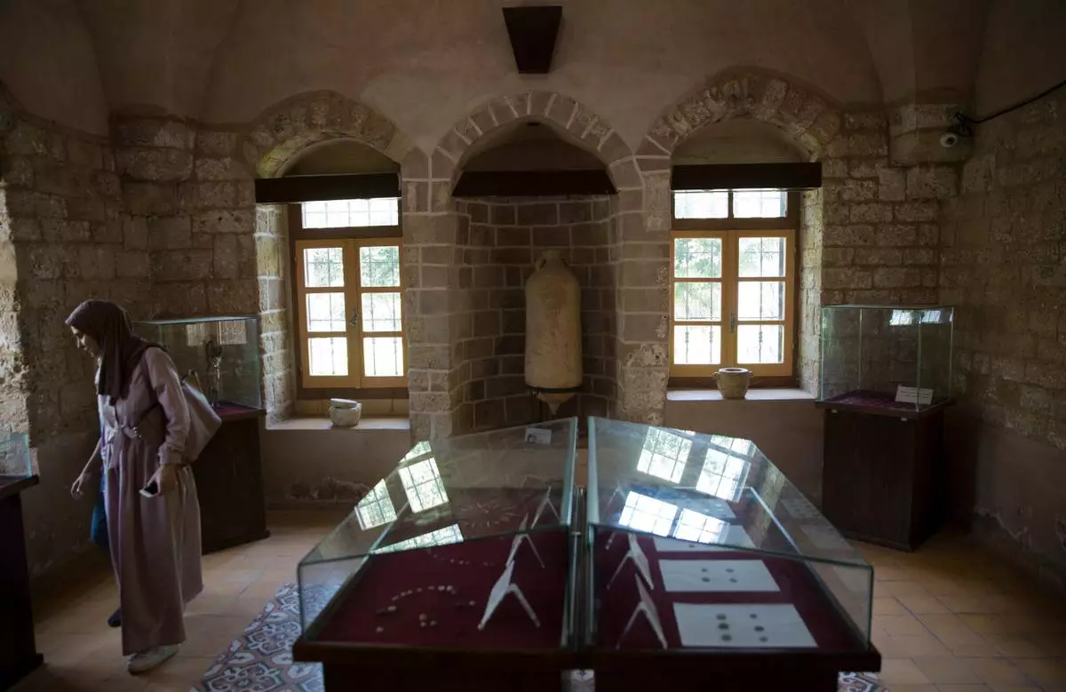 A visitor looks at antiquities displayed at the Pasha Palace, a museum in Gaza City that was later damaged in the Israel-Hamas war, in Gaza City, July 16, 2019. (AP Photo/Khalil Hamra, File)
