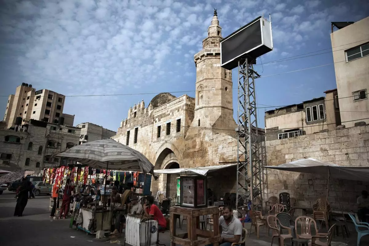 FILE - Palestinian vendors set up outside the Barqouq Castle, which was later damaged during the Israel-Hamas war, in Khan Younis, southern Gaza Strip, Wednesday, July 17, 2019. (AP Photo/Khalil Hamra, File)