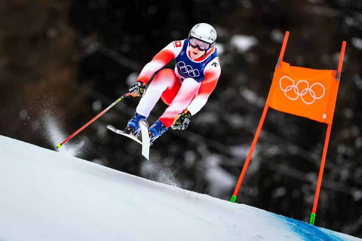 Switzerland's Marco Odermatt takes a jump as he speeds down the course during the alpine ski, men's downhill first official training, at the 2026 Winter Olympics, in Bormio, Italy, Wednesday, Feb. 4, 2026. (Michael Buholzer/Keystone via AP)