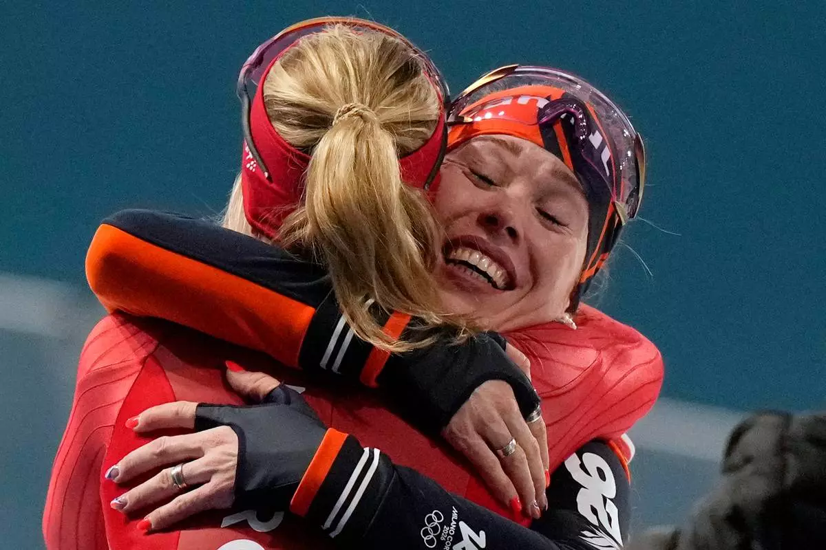 Gold medallist Antoinette Rijpma-de Jong of the Netherlands, right, is congratulated by silver medallist Ragne Wiklund of Norway after the women's 1500 meters speedskating race at the 2026 Winter Olympics, in Milan, Italy, Friday, Feb. 20, 2026. (AP Photo/Luca Bruno)