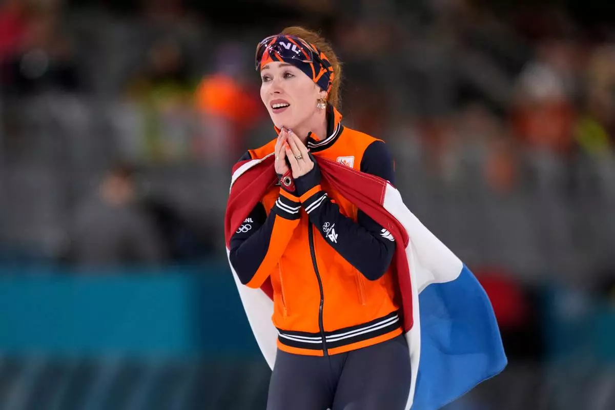 Antoinette Rijpma-de Jong of the Netherlands celebrates winning the gold medal in the women's 1500 meters speedskating race at the 2026 Winter Olympics, in Milan, Italy, Friday, Feb. 20, 2026. (AP Photo/Luca Bruno)