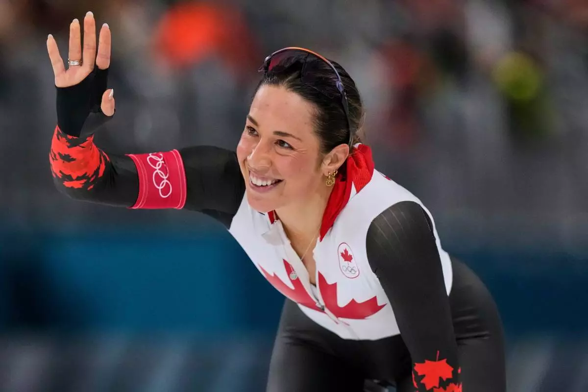 Valerie Maltais of Canada greets fans after competing in the women's 1500 meters speedskating race at the 2026 Winter Olympics, in Milan, Italy, Friday, Feb. 20, 2026. (AP Photo/Luca Bruno)