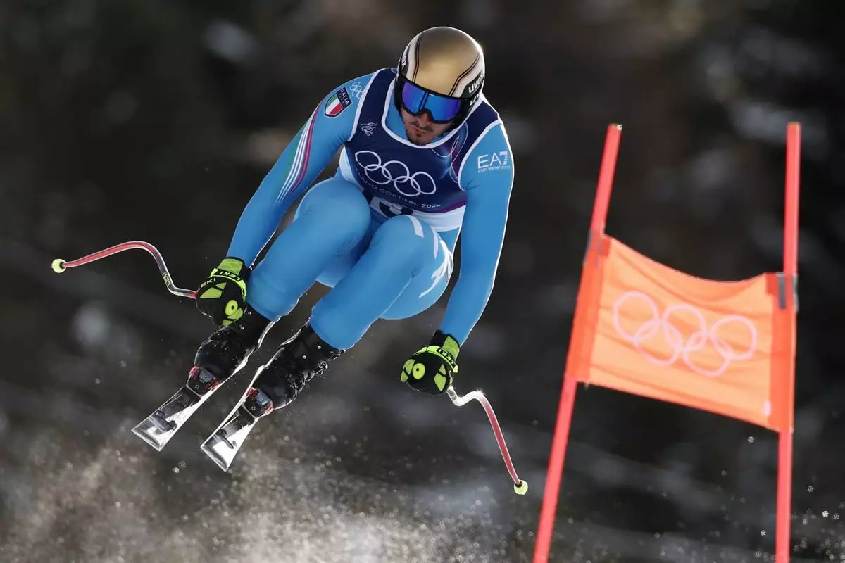 Italy's Dominik Paris speeds down the course during an alpine ski, men's downhill official training, at the 2026 Winter Olympics, in Bormio, Italy, Thursday, Feb. 5, 2026. (AP Photo/Gabriele Facciotti)
