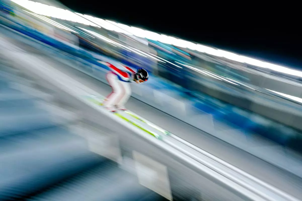 Liu Qi of China goes down the ramp during a ski jumping women's normal hill training session at the 2026 Winter Olympics in Predazzo, Italy, Thursday, Feb. 5, 2026. (AP Photo/Matthias Schrader)