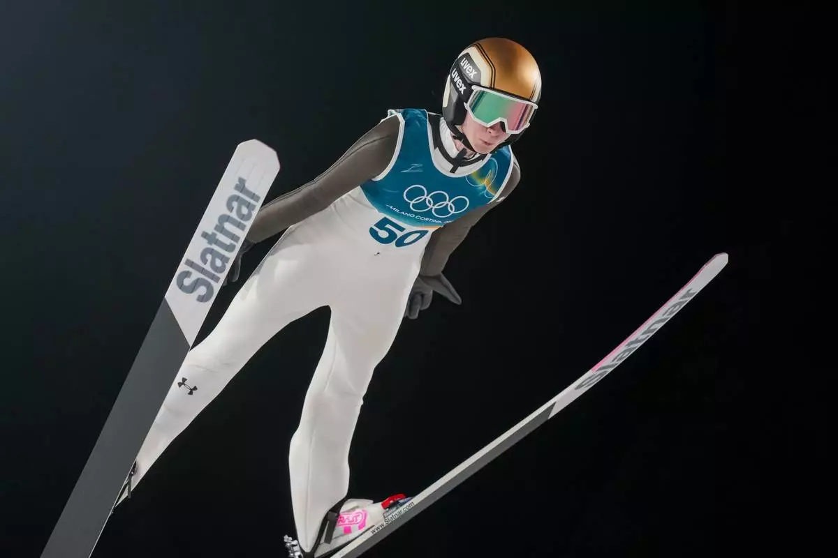 Nika Prevc, of Slovenia, soars through the air during her first round jump of the ski jumping women's large hill individual at the 2026 Winter Olympics, in Predazzo, Italy, Sunday, Feb. 15, 2026. (AP Photo/Evgeniy Maloletka)