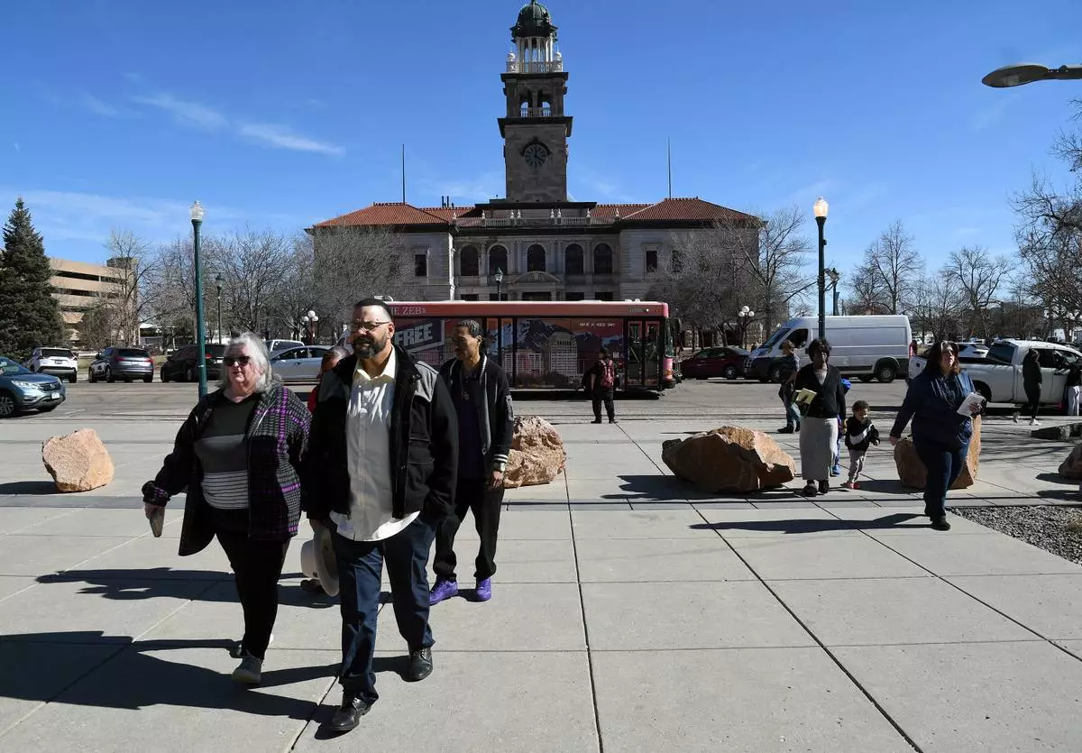 Derrick Johnson, whose mother's body was one of 189 left to decay in the Return to Nature Funeral Home in Penrose, Colo., walks toward the El Paso County Courthouse for owner Jon Hallford's sentencing in Colorado Springs, Colo., Friday, Feb. 6, 2026. (AP Photo/Thomas Peipert)