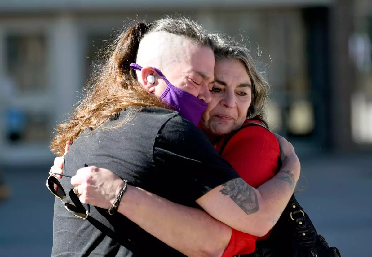 Crystina Page, left, hugs Angelika Stedman outside of the El Paso County Courthouse in Colorado Springs, Colo., Friday, Feb. 6, 2026, ahead of the sentencing of Return to Nature funeral home owner Jon Hallford. (AP Photo/Thomas Peipert)