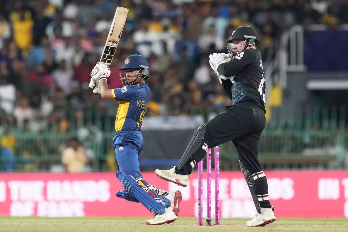 Sri Lanka's Dunith Wellalage plays a shot during the T20 World Cup cricket match between Sri Lanka and New Zealand in Colombo, Sri Lanka, Wednesday, Feb. 25, 2026. (AP Photo/Eranga Jayawardena)
