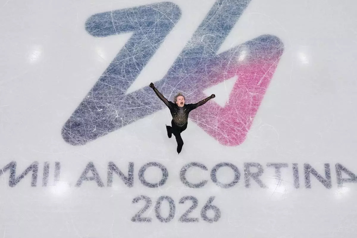 Ilia Malinin of the United States wobbles while competing during the figure skating men's team event at the 2026 Winter Olympics, in Milan, Italy, Sunday, Feb. 8, 2026. (AP Photo/Bernat Armangue)