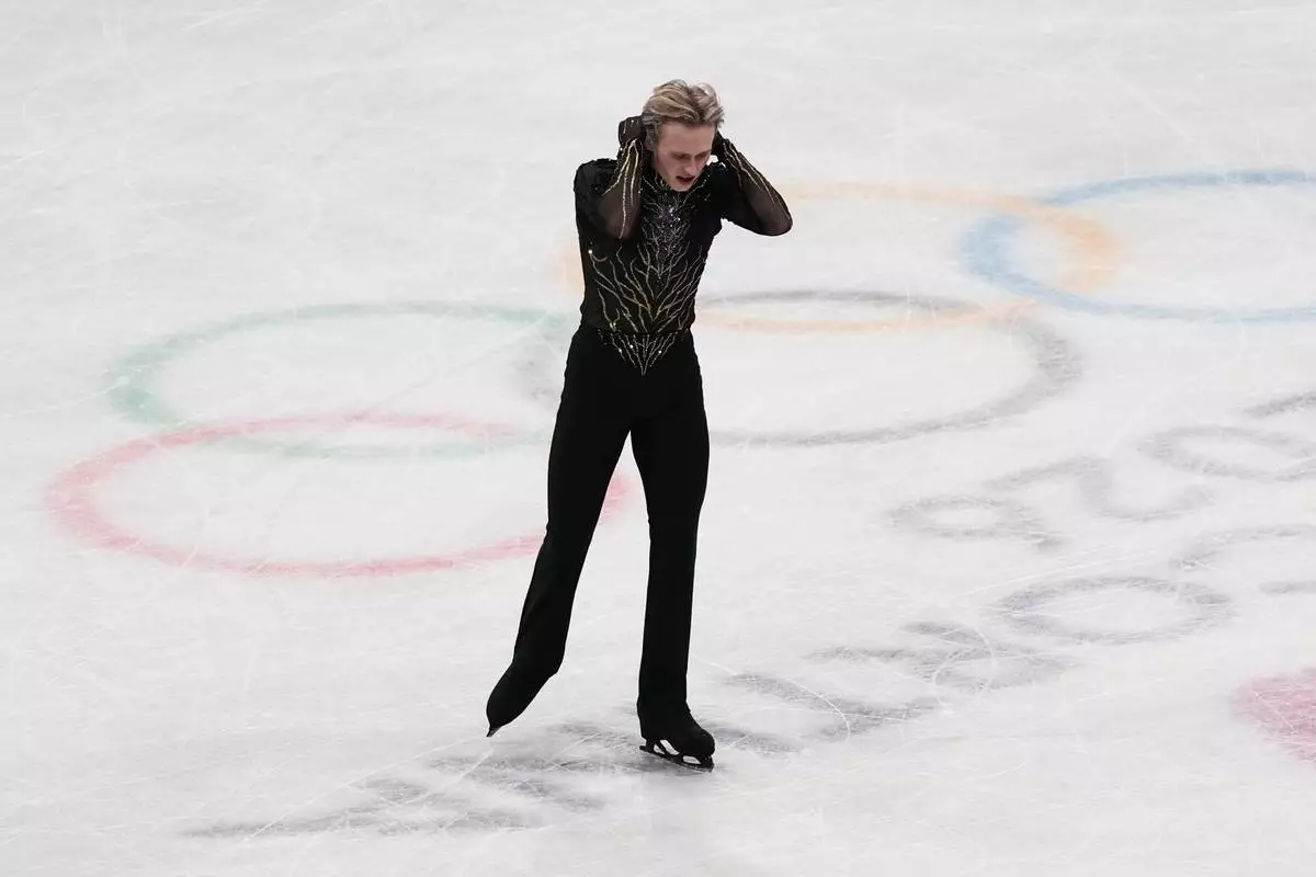 Ilia Malinin of the United States does a back flip while competing during the men's free skate program in figure skating at the 2026 Winter Olympics, in Milan, Italy, Friday, Feb. 13, 2026. (AP Photo/Stephanie Scarbrough)