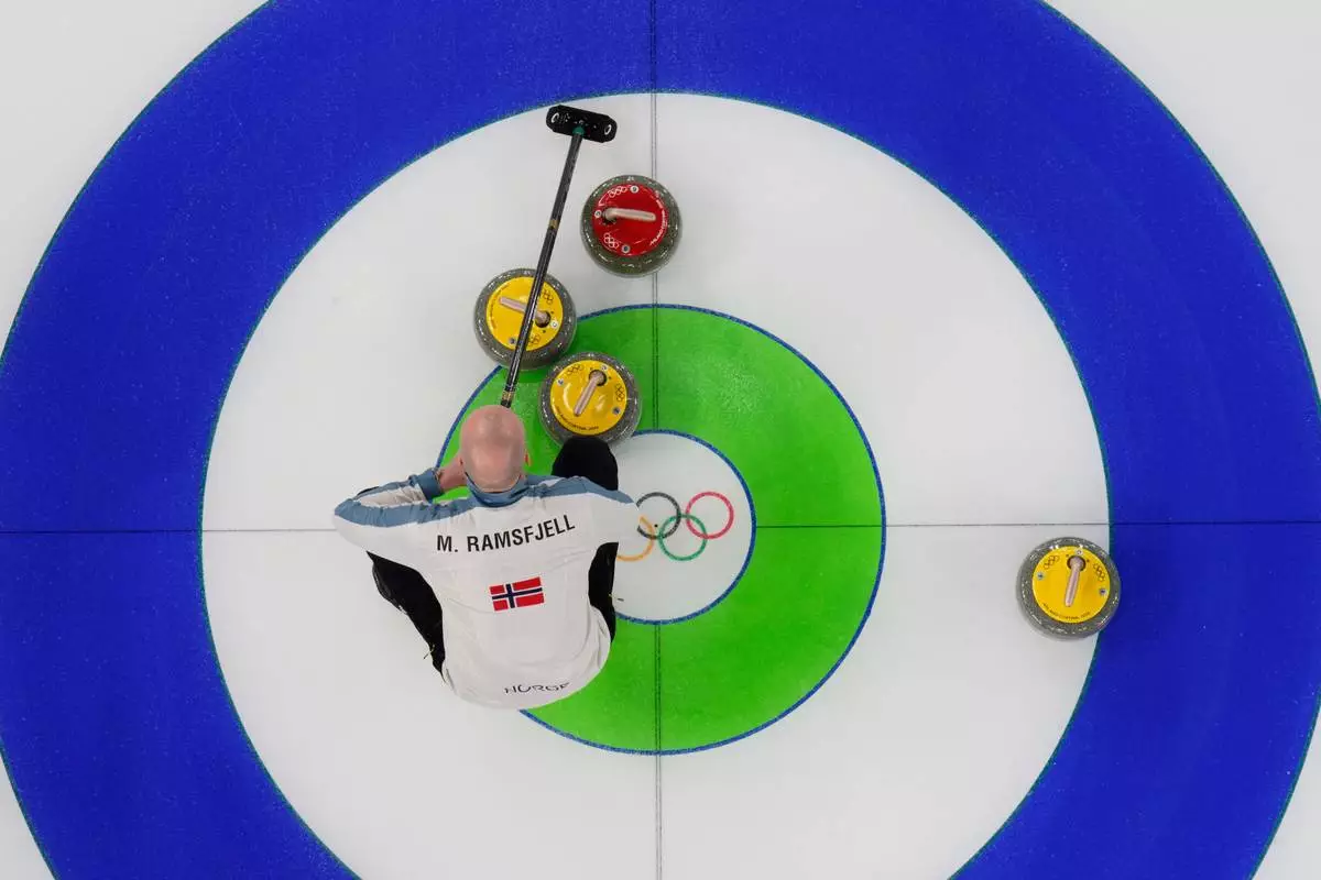Norway's Magnus Ramsfjell looks over the stones during a men's curling round robin match against China at the 2026 Winter Olympics, in Cortina d'Ampezzo, Italy, Friday, Feb. 13, 2026. (AP Photo/David J. Phillip)