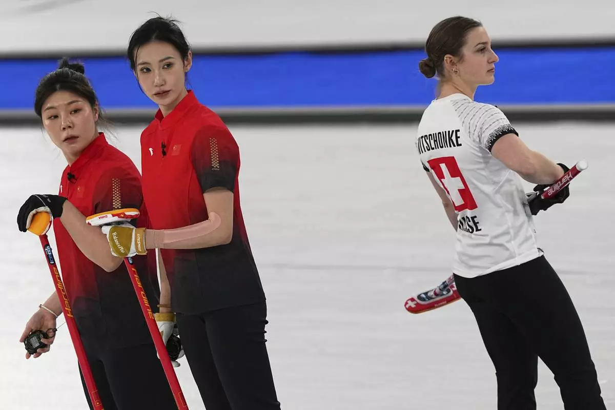 China's Dong Ziqi, Jiang Jiayi and Switzerland's Selina Witschonke compete during the women's curling round robin session at the 2026 Winter Olympics, in Cortina d'Ampezzo, Italy, Monday, Feb. 16, 2026. (AP Photo/Fatima Shbair)