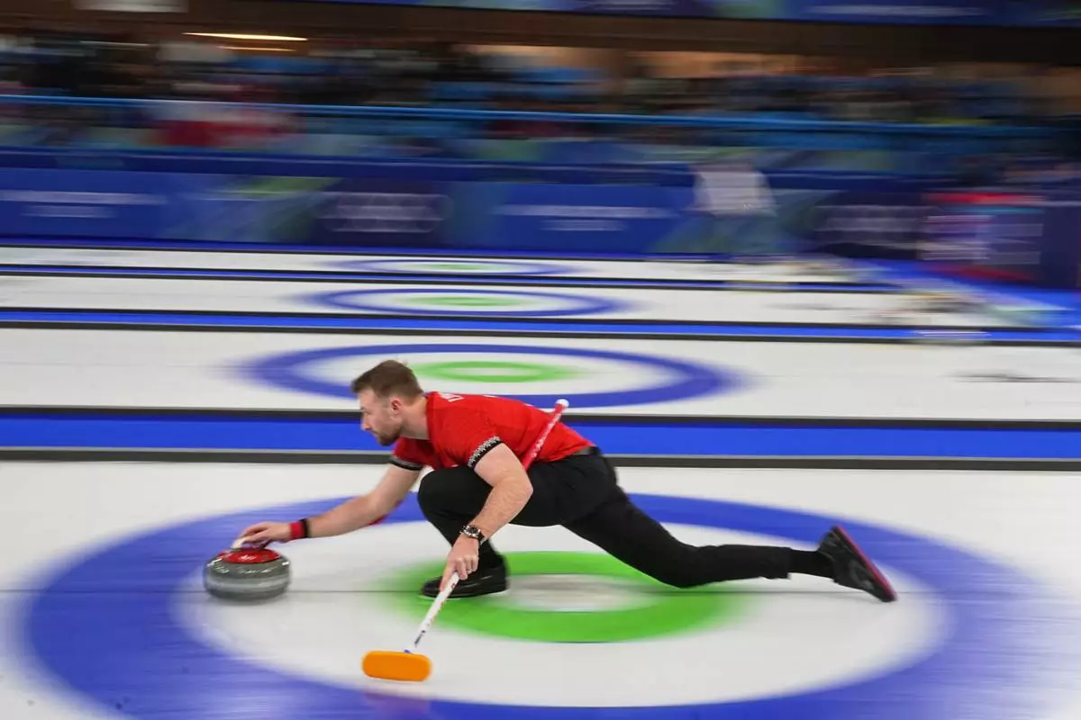 Switzerland's Yannick Schwaller in action during the mixed doubles round robin phase of the curling competition against Canada, at the 2026 Winter Olympics, in Cortina d'Ampezzo, Italy, Monday, Feb. 9, 2026. (AP Photo/Fatima Shbair)