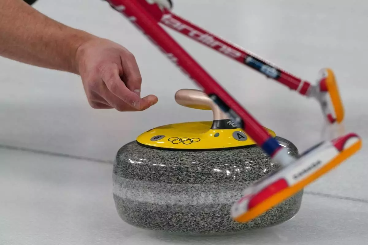 Canada's Brad Jacobs in action during the men's curling round robin session against China, at the 2026 Winter Olympics, in Cortina d'Ampezzo, Italy, Sunday, Feb. 15, 2026. (AP Photo/Misper Apawu)