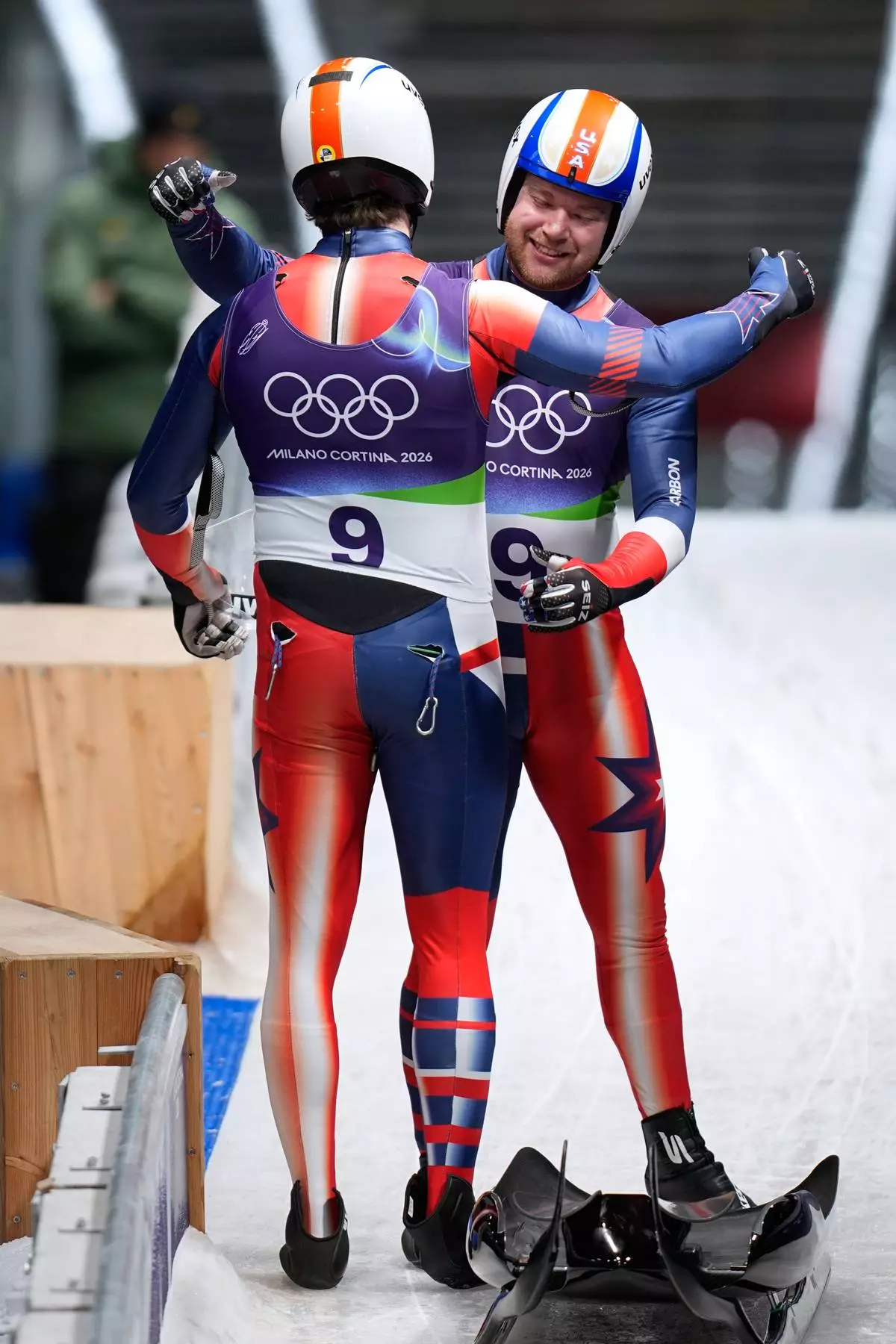 United States' Zachary Digregorio, right, and Sean Hollander, left, arrive at the finish during a men's doubles luge run at the 2026 Winter Olympics, in Cortina d'Ampezzo, Italy, Wednesday, Feb. 11, 2026. (AP Photo/Aijaz Rahi)