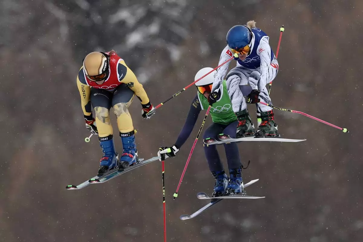 From left, Germany's Daniela Maier (1), Sweden's Sandra Naeslund (2) and Switzerland's Fanny Smith (3) compete during the women's ski cross finals at the 2026 Winter Olympics, in Livigno, Italy, Friday, Feb. 20, 2026. (AP Photo/Gabriele Facciotti)
