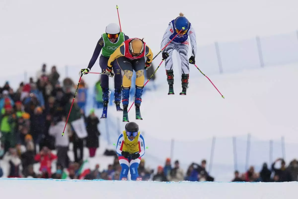 From left, Sweden's Sandra Naeslund (2), Germany's Daniela Maier (1) and Switzerland's Fanny Smith (3) compete during the women's ski cross finals at the 2026 Winter Olympics, in Livigno, Italy, Friday, Feb. 20, 2026. (AP Photo/Rebecca Blackwell)