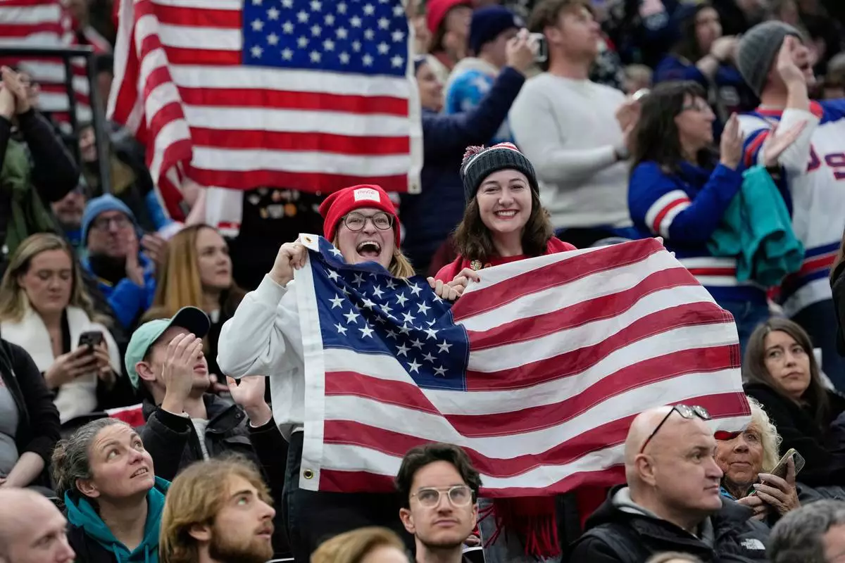 US supporters cheer during a preliminary round match of women's ice hockey between USA and Canada at the 2026 Winter Olympics, in Milan, Italy, Tuesday, Feb. 10, 2026. (AP Photo/Petr David Josek)