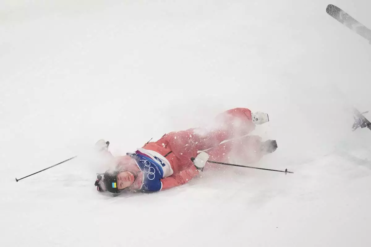 Ukraine's Kateryna Kotsar crashes as she competes in the women's freestyle skiing big air qualifications at the 2026 Winter Olympics, in Livigno, Italy, Saturday, Feb. 14, 2026. (AP Photo/Abbie Parr)