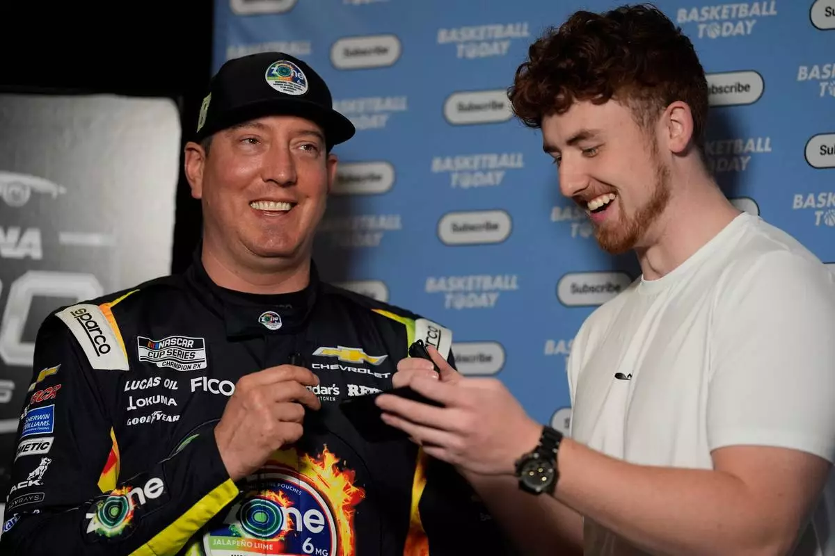 Kyle Busch speaks with Justin Leusner about basketball trivia for his Basketball Today YouTube channel during a NASCAR Daytona 500 media day, Wednesday, Feb. 11, 2026, in Daytona, Fla. (AP Photo/Mike Stewart)