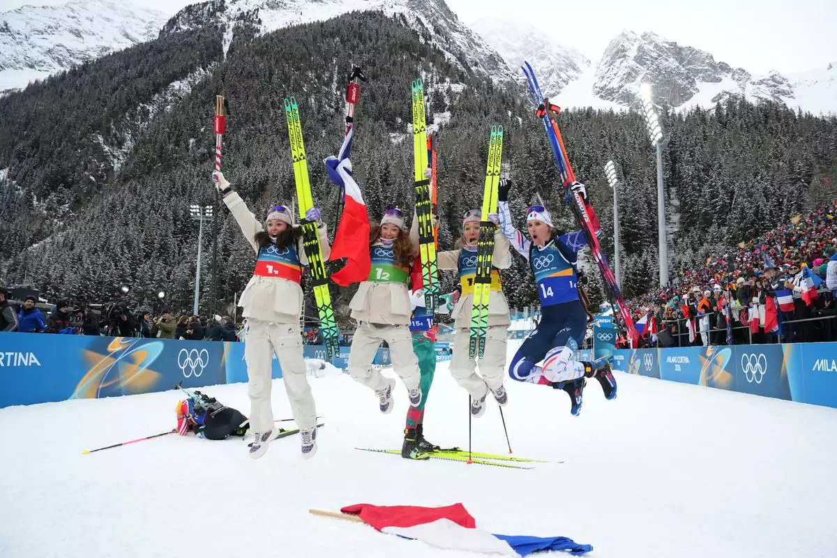 France's Camille Bened, from left, Lou Jeanmonnot, Oceane Michelon and Julia Simon, celebrate winning gold in the women's 4x6-kilometer relay biathlon race at the 2026 Winter Olympics in Anterselva, Italy, Wednesday, Feb. 18, 2026. (AP Photo/Andrew Medichini)