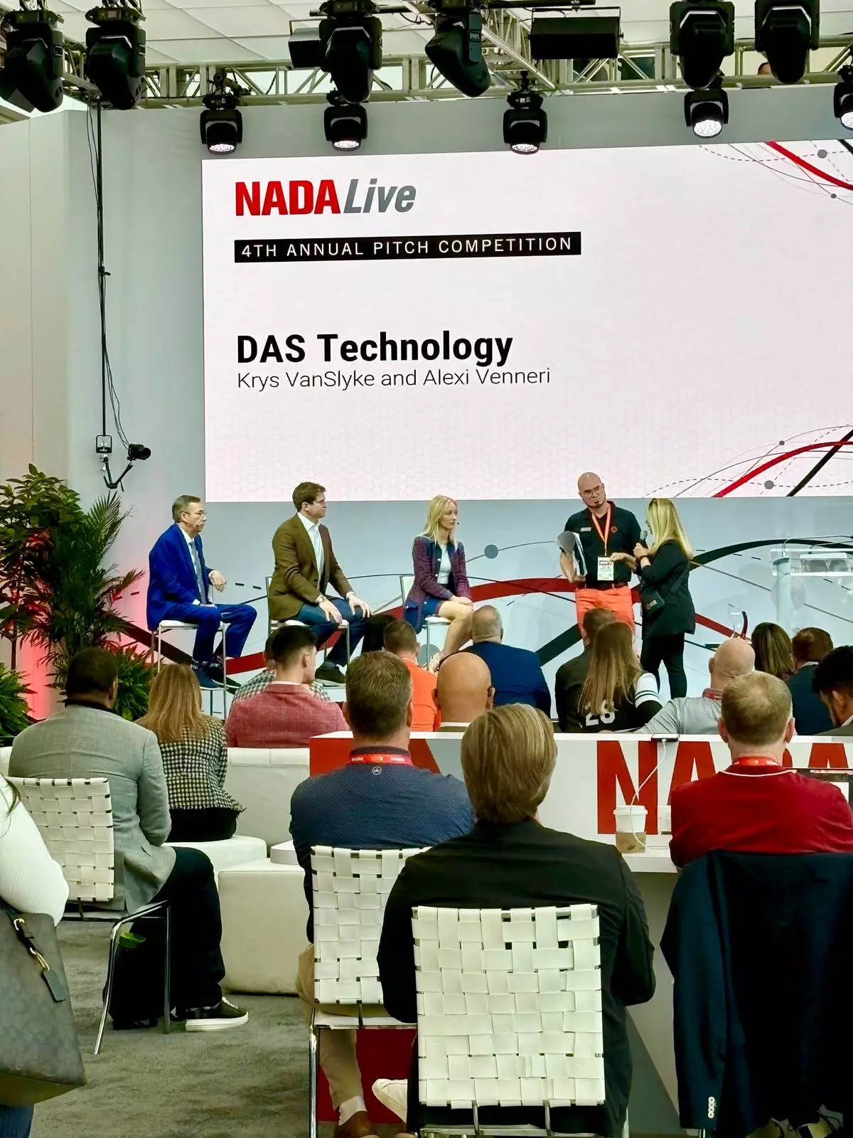 DAS Technology SVP of Marketing Krys VanSlyke and Co-founder and CEO Alexi Venneri present Power AI Search ver. X during the NADA 2026 Exhibitor Best New Product Pitch Competition in Las Vegas.